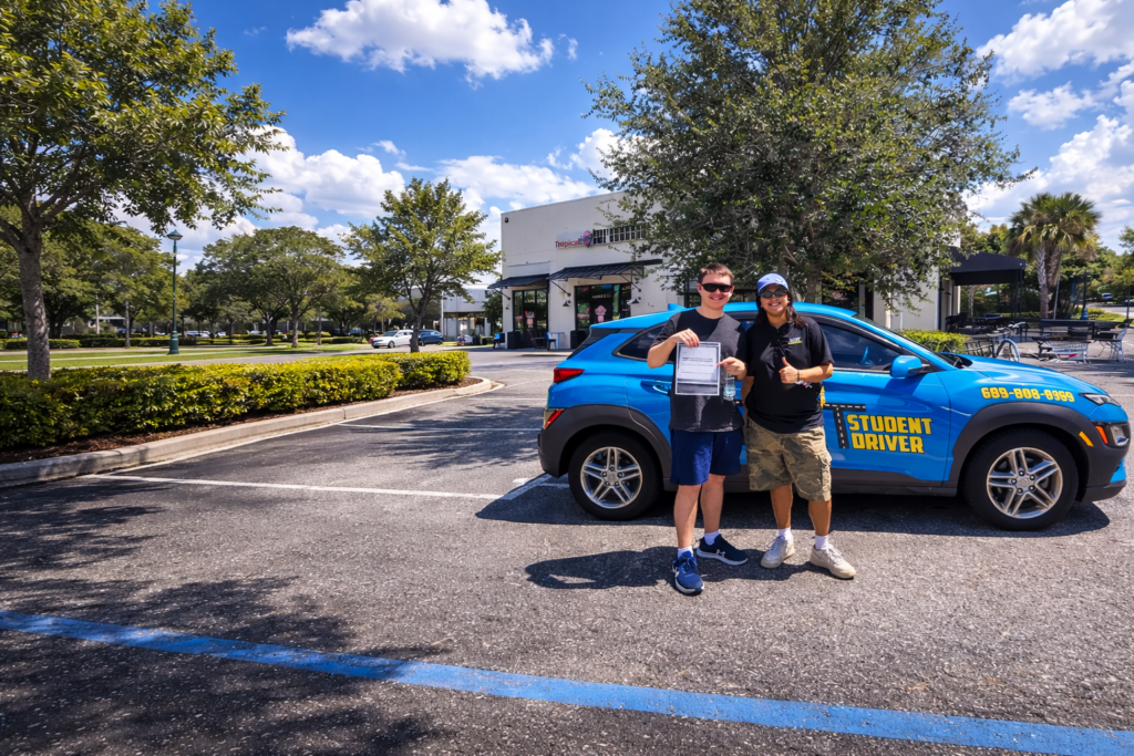 Driving instructor with teen student who passed their driving test